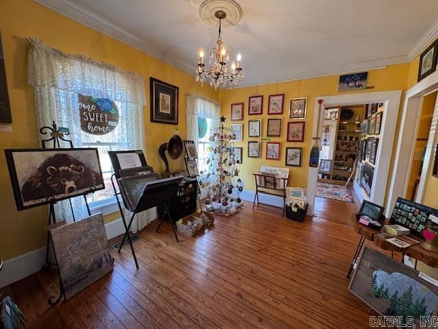 misc room featuring an inviting chandelier, hardwood / wood-style floors, and crown molding