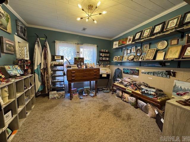 carpeted office space featuring crown molding and an inviting chandelier