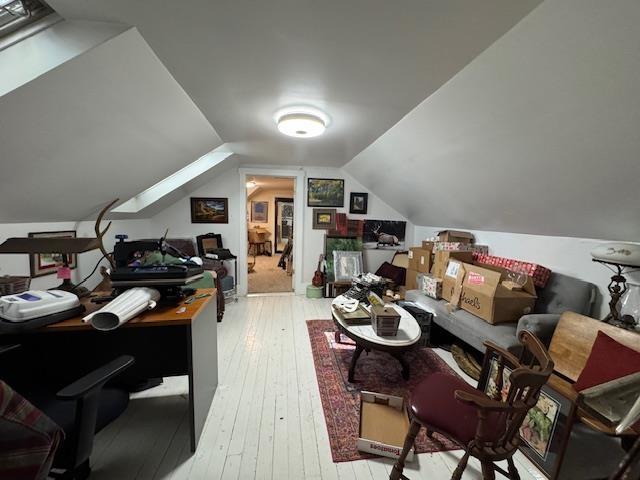 interior space with vaulted ceiling and light wood-type flooring