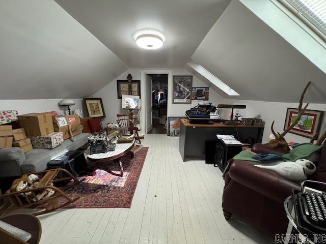 interior space featuring hardwood / wood-style flooring and lofted ceiling