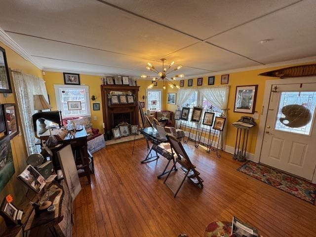 dining space featuring an inviting chandelier, hardwood / wood-style floors, and a fireplace