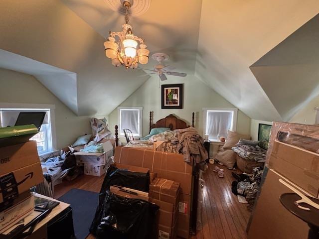 bedroom featuring vaulted ceiling, hardwood / wood-style floors, and a notable chandelier