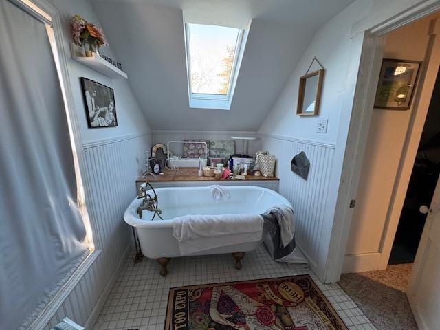 bathroom featuring vaulted ceiling with skylight