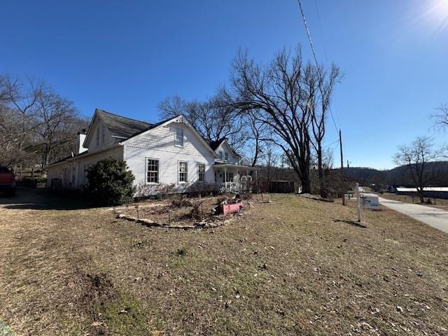 view of side of home featuring a yard