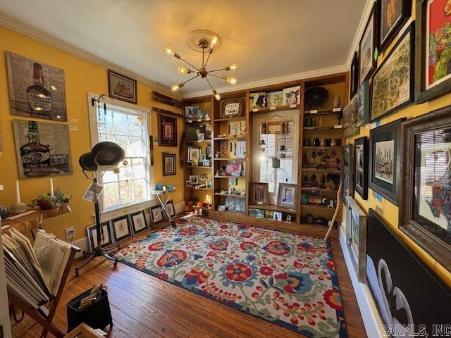 office with crown molding, a chandelier, and hardwood / wood-style flooring