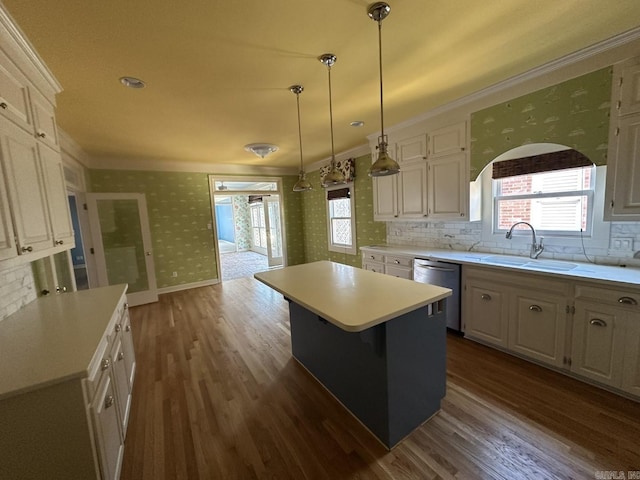 kitchen with sink, a center island, dishwasher, pendant lighting, and decorative backsplash