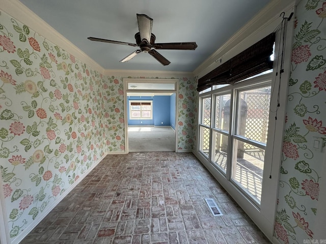 unfurnished room featuring ornamental molding and ceiling fan