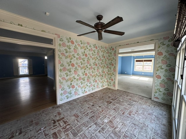 spare room featuring ornamental molding and ceiling fan