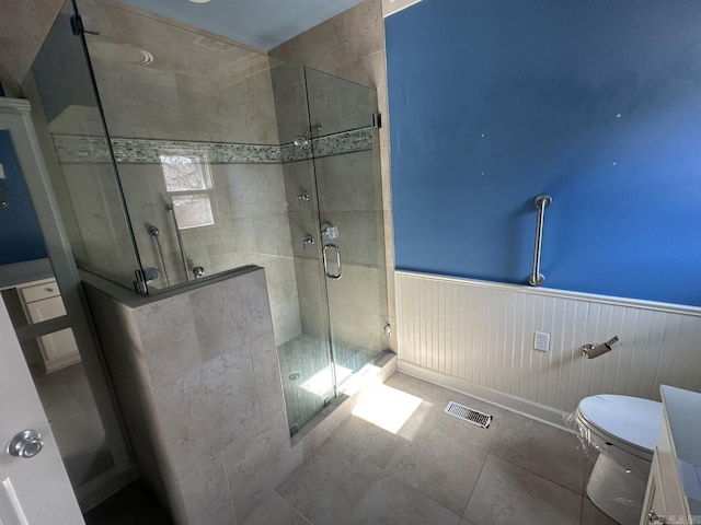 bathroom featuring toilet and walk in shower