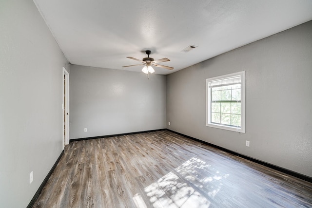 empty room featuring ceiling fan and light wood-type flooring