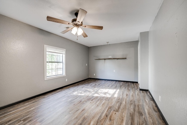 unfurnished room featuring ceiling fan and light wood-type flooring