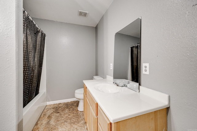 full bathroom with vanity, shower / bath combination with curtain, and toilet