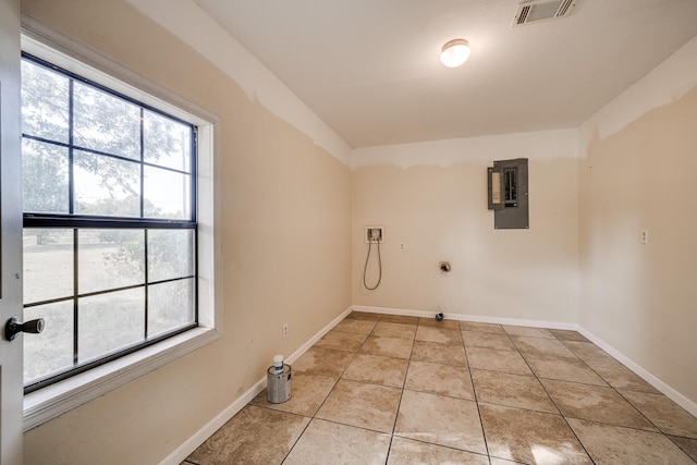 clothes washing area featuring electric dryer hookup, light tile patterned floors, hookup for a washing machine, and electric panel