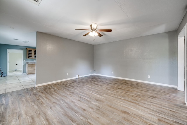 spare room with ceiling fan and light hardwood / wood-style floors