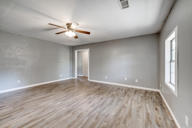 spare room featuring ceiling fan and light wood-type flooring