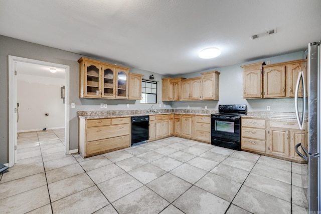 kitchen with light brown cabinetry, sink, light tile patterned floors, and black appliances