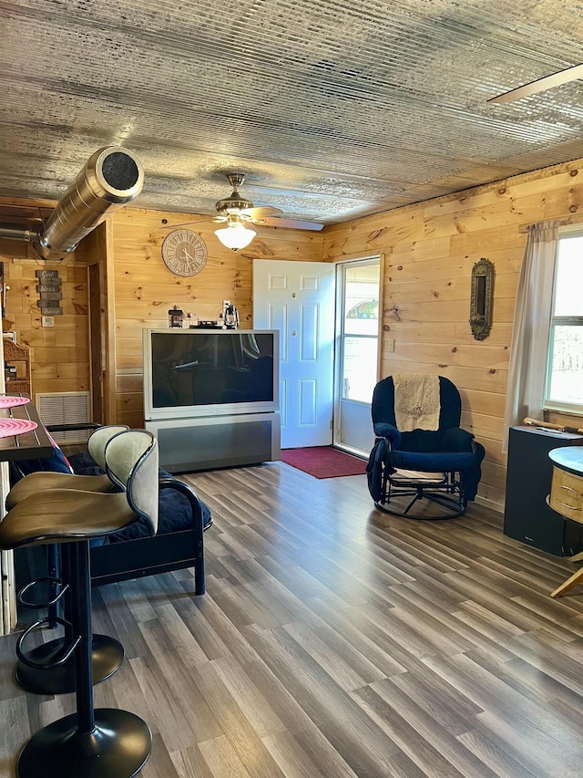 living room with wooden walls, wooden ceiling, and wood-type flooring