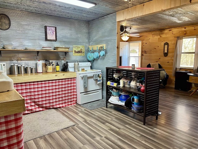 kitchen featuring ceiling fan, butcher block counters, hardwood / wood-style floors, white range with electric stovetop, and wood walls