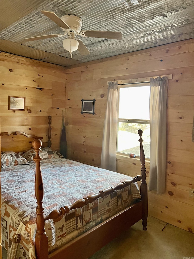 bedroom with carpet flooring, wooden ceiling, ceiling fan, and wood walls