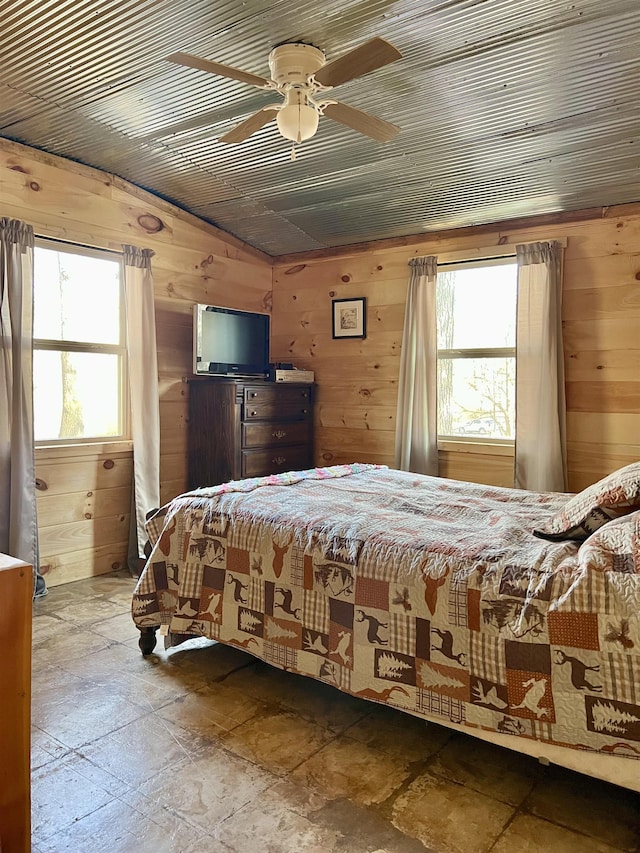 bedroom with wood ceiling, ceiling fan, and wooden walls