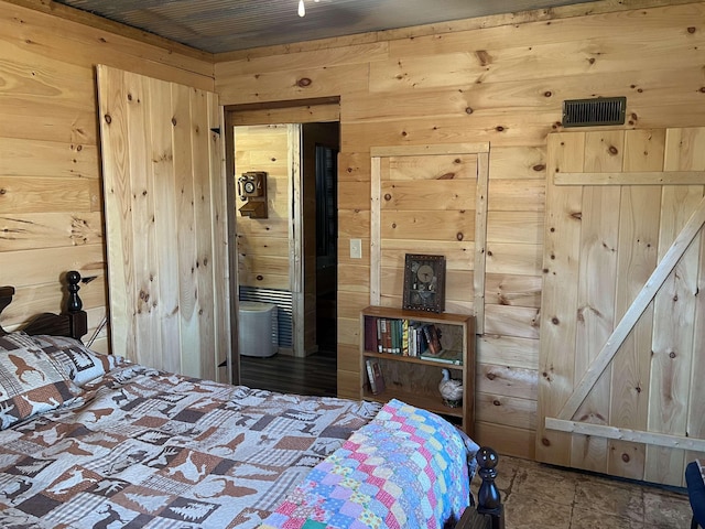 bedroom featuring wooden ceiling and wood walls