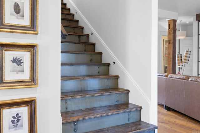 stairway featuring wood-type flooring