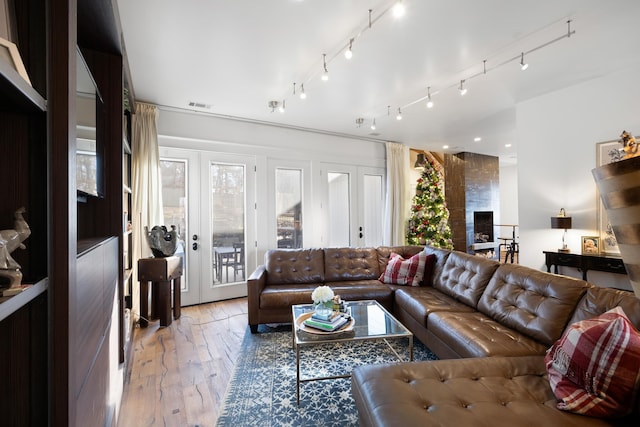 living room with light hardwood / wood-style floors and french doors