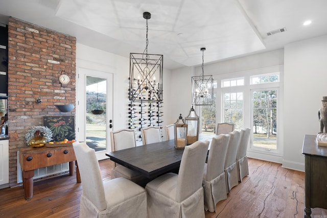 dining room featuring hardwood / wood-style flooring and an inviting chandelier