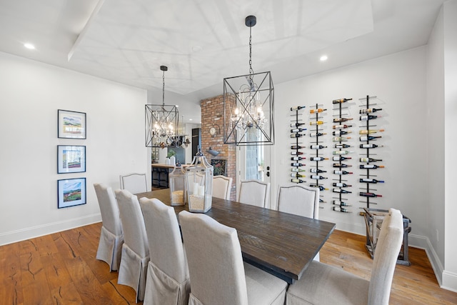 dining room featuring a notable chandelier and light wood-type flooring