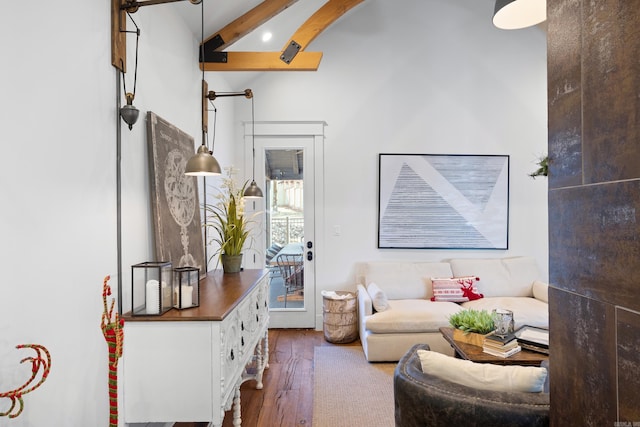 living room with hardwood / wood-style flooring and lofted ceiling with beams