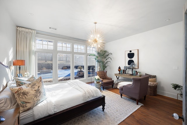 bedroom featuring an inviting chandelier and dark wood-type flooring