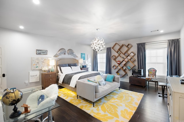 bedroom with dark wood-type flooring and a chandelier