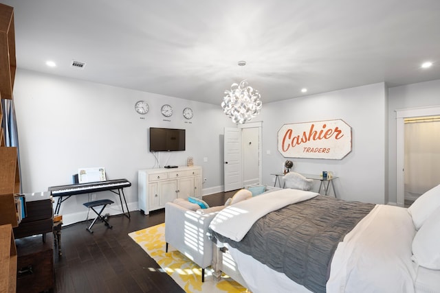 bedroom with dark hardwood / wood-style floors, a closet, and a notable chandelier