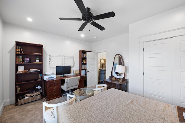 bedroom with light carpet, ceiling fan, and a closet