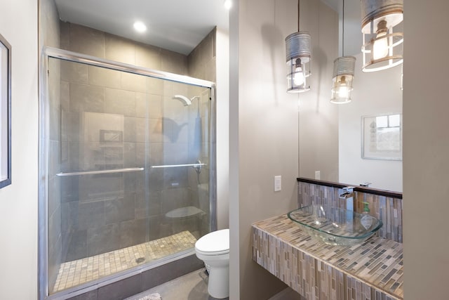 bathroom with an enclosed shower and toilet