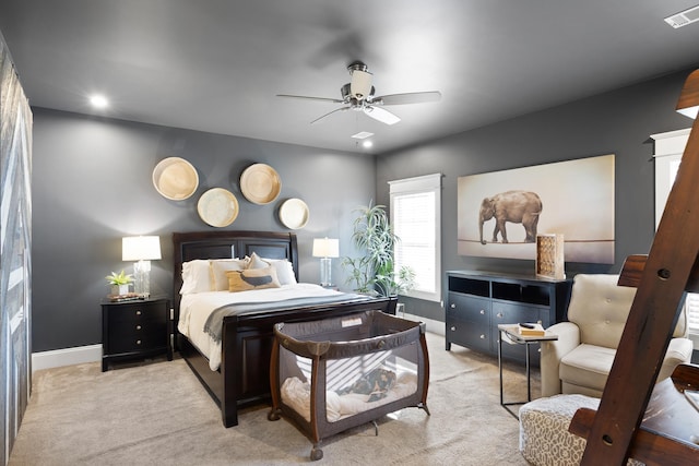 bedroom featuring light colored carpet and ceiling fan