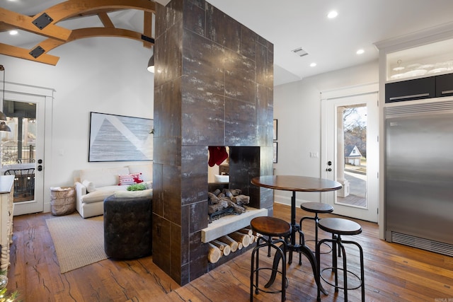 interior space with hardwood / wood-style flooring and vaulted ceiling