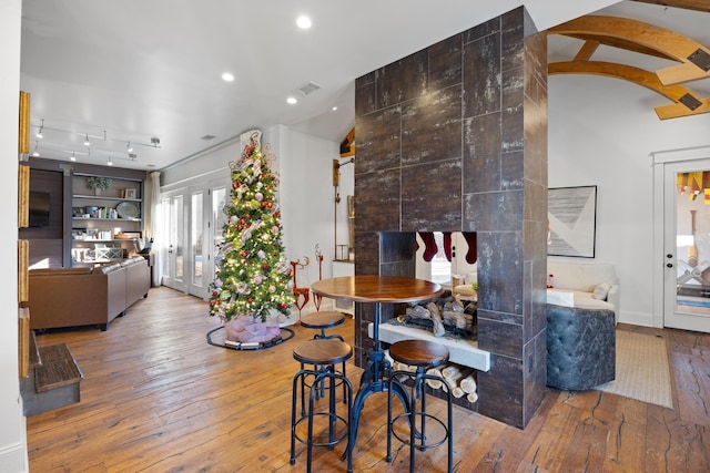 dining area with light hardwood / wood-style flooring, french doors, and vaulted ceiling