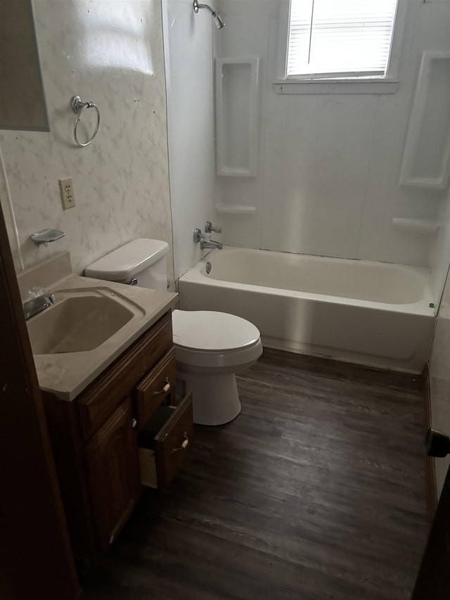 full bathroom with shower / bath combination, vanity, hardwood / wood-style floors, and toilet