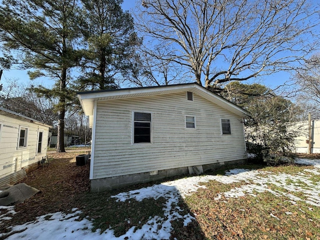 view of snowy exterior with central AC