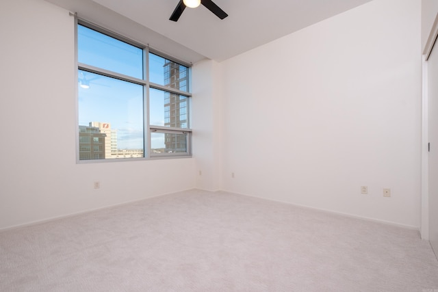 spare room with ceiling fan and carpet floors