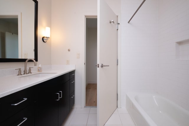 bathroom with tiled shower / bath, tile patterned floors, and vanity