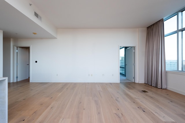 spare room featuring light wood-type flooring