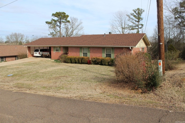 ranch-style home featuring a carport and a front yard