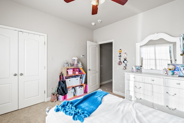 bedroom featuring light carpet, a closet, and ceiling fan