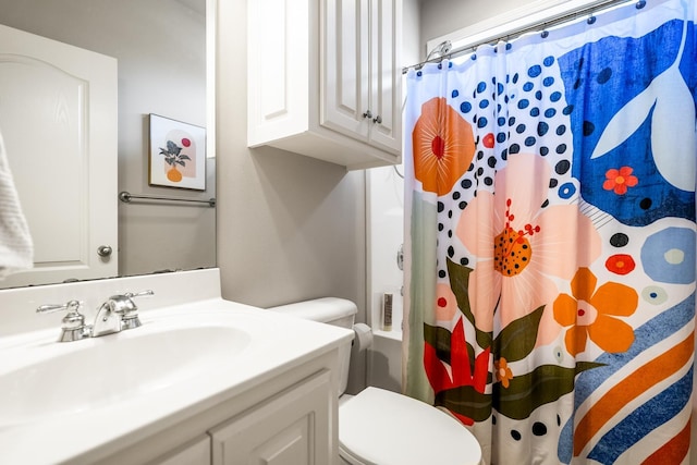 bathroom featuring vanity, curtained shower, and toilet