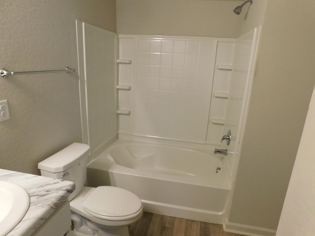 full bathroom featuring wood-type flooring, toilet,  shower combination, and vanity