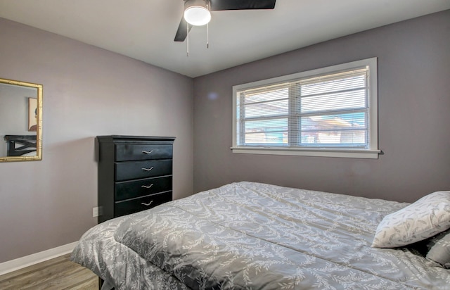 bedroom with ceiling fan and wood-type flooring