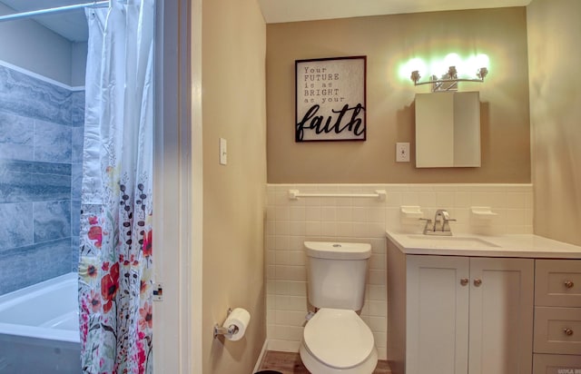 bathroom featuring vanity, tile walls, and toilet