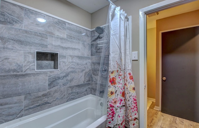 bathroom with wood-type flooring and shower / bathtub combination with curtain